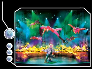 Franz Harary performing a stage illusion with fire and aerial performers